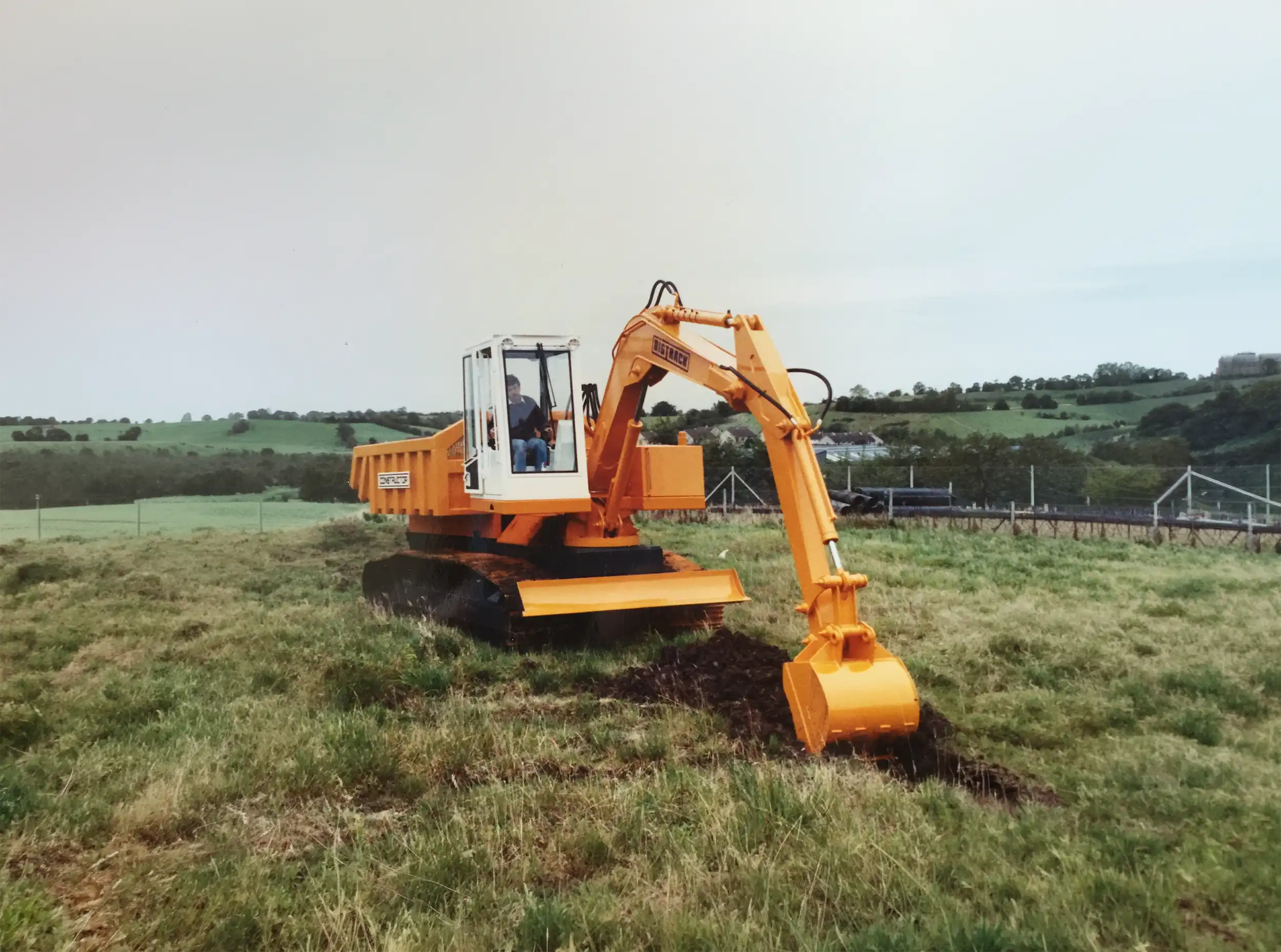 Early Chieftain orange excavator working on a hillside